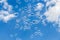 A group of transparent rainbow soap bubbles on the blue sky with white clouds background