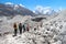 Group of travelers walks on Ngozumpa glacier in Himalayas
