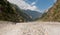 A group of trekkers in riverbed on Manaslu circuit with view of Mount Manaslu range 8 156 meters. Himalayas, Manaslu Glacier