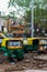 group of tuk-tuks parked in mud and garbage on a street in delhi