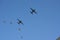 A group of Two Fixed Wing Aircrafts and Four Gray Fighter Aircrafts Going Together Upwards