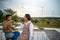 Group of two LGBTQ friends sitting and talking laughing happy on the roof of the coffee shop