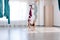 Group of two young yogi women doing antigravity fly yoga using blue hammock together