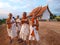 Group of unidentified Buddhist novice smiling beside of church