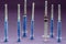 Group of used syringes on a lilac background