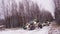 A group of UTV SXS off-road buggies ride through the winter forest and drift