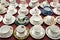 Group of various English vintage porcelain teacups with floral pattern on colored background