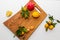 Group of various fruit consists half of tangerines, pomegranates,lemon close up fresh fruit on wooden cutting board