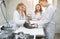 A group of veterinarians examine a cat on a table in a veterinary clinic. Four veterinary clinic doctors with a