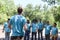 Group of volunteer protest against earth pollution and global warming. Back of head leader standing and raising fists up to cheer