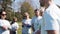 Group of volunteers listening to mentor in park