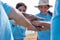 A group of volunteers wearing blue voluntary t-shirts doing stacked hands together