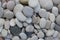 Group of white, grey and black pebbles, one by ony, simplicity stone background