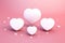 Group of white hearts on pink background. Perfect for Valentine's Day or romantic-themed designs