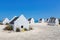 Group of white slave houses on bonairean beach