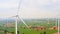Group of wind turbines on wind farm mountain field, drone aerial view. Electricity production industry, sustainable clean energy