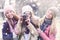 Group of winter college girls with vintage camera on snowy day