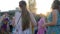 Group of woman in Indian clothes have fun on open air, crowd female dancing with raised hands on street,