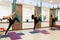 Group of womans doing fly yoga stretching exercises in gym. Fit and wellness lifestyle