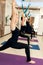 Group of womans doing yoga exercises in gym. Fit and wellness lifestyle