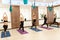 Group of womans doing yoga exercises in gym. Fit and wellness lifestyle