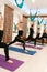 Group of womans doing yoga exercises in gym. Fit and wellness lifestyle