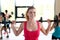 Group of women with barbells in gym