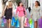 Group Of Women Carrying Shopping Bags On City Street