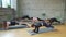 Group of women doing plank exercice in hall.