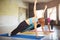 Group of women doing side plank static exercise