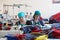 A group of women in a factory seamstress sew special clothes for