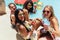 Group of women hanging out by the pool with drinks