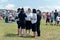 group of women in police uniform stand in a clearing while on duty amid people