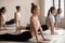 Group of women practicing yoga lesson, upward facing dog pose