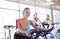 Group of women riding on exercise bike in gym