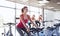 Group of women riding on exercise bike in gym