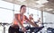 Group of women riding on exercise bike in gym