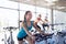 Group of women riding on exercise bike in gym