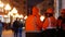 Group of women road workers in a corporate orange uniform and orange helmets