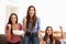 Group Of Women Sitting On Sofa Watching Sport Together