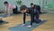 Group of women stretching in hall.