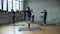 Group of women stretching in hall.