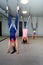 Group of women three hang in a hammock upside down. Fly yoga class. Healthy lifestyle, healthy hobby