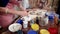 Group of women are working in pottery workshop, making clay cups and paint