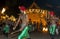 A group of Wood Tappers perform in front of the Temple of the Sacred Tooth Relic during the Esala Perahera in Kandy, Sri Lanka.