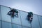 Group of workers cleaning windows service on high rise building