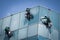 Group of workers cleaning windows service on high rise building