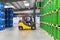 group of workers in the logistics industry work in a warehouse with chemicals - lifting truck