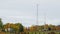 Group workers preparing to repair a wind turbine in a small farm. Crane boom lifts