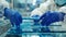 A group of workers wearing protective gear carefully handle sheets of glass ready to be and fitted for solar panel